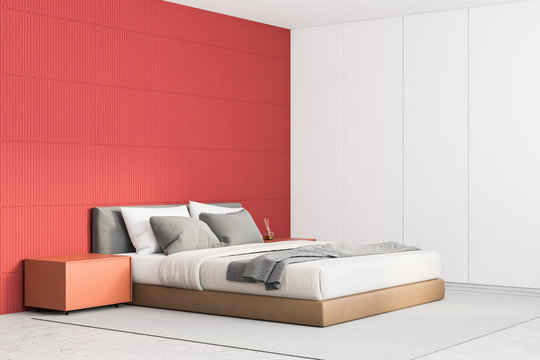 Red master bedroom corner with orange tables