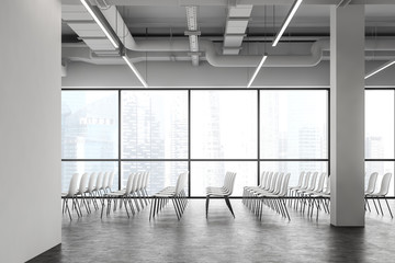 Rows of chairs in panoramic white lecture room