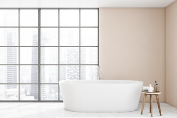 Fototapeta na wymiar White bathtub in panoramic beige bathroom