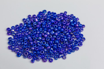 heap with tiny blue iridescent glass beads for embroidery