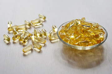 Fish oil pills. Omega-3 gel capsules. Food supplement obtained from cod liver. Healthcare and medical concept. Soft selective focus.