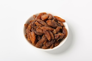 Orange raisins dry in the sun and stand alone on a white background