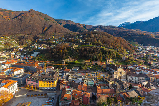 Stunning aerial panorama view of Bellinzona old town with Montebello castle Sasso Corbaro Castle and Swiss Alps with blue sky cloud in background, on sunny autumn day, Ticino, Switzerland