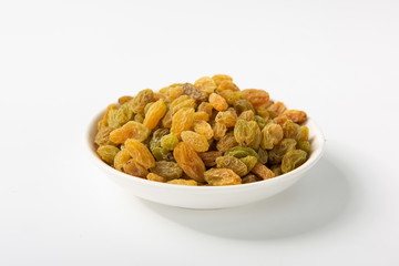 The green raisins dry in the sun and stand alone on a white background