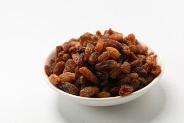 Orange raisins dry in the sun and stand alone on a white background