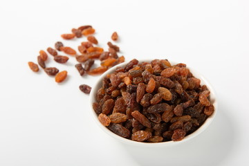 Orange raisins dry in the sun and stand alone on a white background
