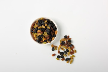 Raisins of all colors mixed and dried in isolation on a white background