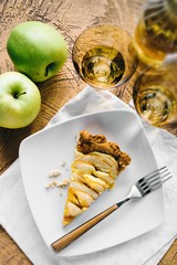A slice of homemade apple tart on white plate
