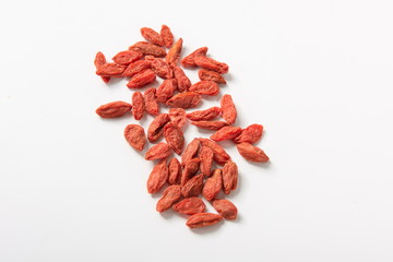 Orange red fresh wolfberry, dried in the sun and isolated in the white background