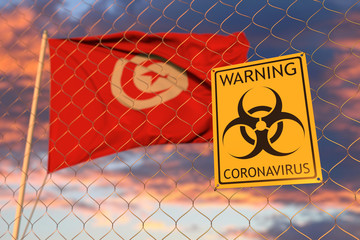 Coronavirus biohazard sign against the Tunisian flag. Restricted border crossing or quarantine in Tunisia. Conceptual 3D rendering