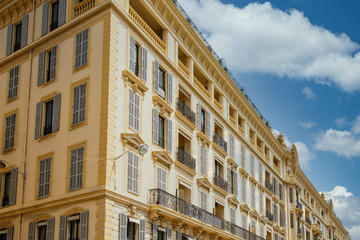 Fototapeta na wymiar A large yellow building in classic architecture in Nice, France