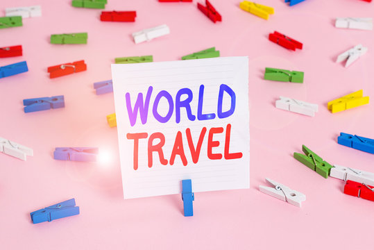 Word writing text World Travel. Business photo showcasing the movement of showing between distant geographical locations Colored clothespin papers empty reminder pink floor background office pin