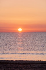 Sunrise on the beach with the sun rising.