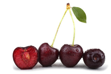 Three cherries with a half and leaves