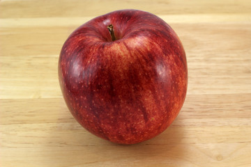 Red gala apple on board