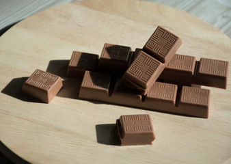 pieces of chocolate on wooden background