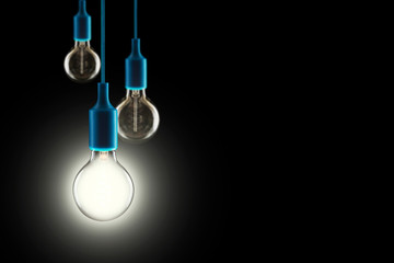 Fototapeta na wymiar Idea and teamwork concept - Vintage incandescent bulbs on black background