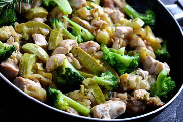 Skinless boneless chicken with vegetables on a pan