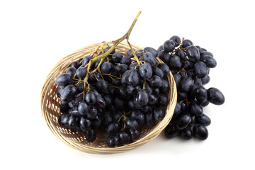 Black grape on wicker plate