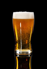 glass of beer on a black background