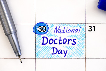 Reminder National Doctors Day in calendar with blue pen.