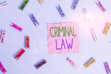 Text sign showing Criminal Law. Business photo text legal system which relates to punishing those commits crime Colored clothespin rectangle shaped reminder paper light blue background