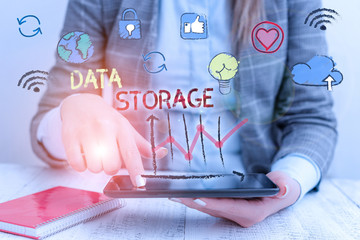 Writing note showing Data Storage. Business concept for the act of archiving data in...