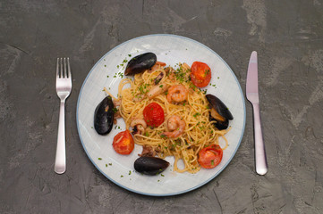 Spaghetti pasta with shrimp, mussels, tomatoes and cheese. Tasty, traditional Italian food