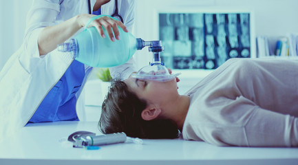 Doctor putting an oxygen mask in the hospital