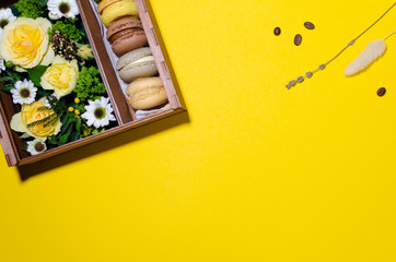 flowers and macaroons in a gift box made of plywood
