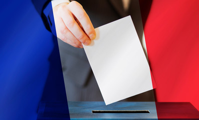 elections in France hand  putting  vote in the ballot box