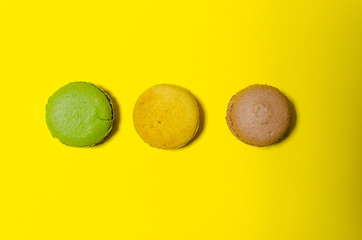 colored macaroons on a yellow background