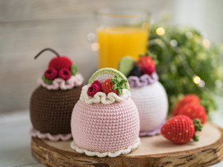 Knitted cakes. Concept. Sweet tooth.Stylization. Needlework. Environmentally friendly toys for children to develop fine motor skills. Hand made toys. 
