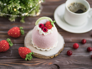 Obraz na płótnie Canvas Knitted cakes. Concept. Sweet tooth.Stylization. Needlework. Environmentally friendly toys for children to develop fine motor skills. Hand made toys. 