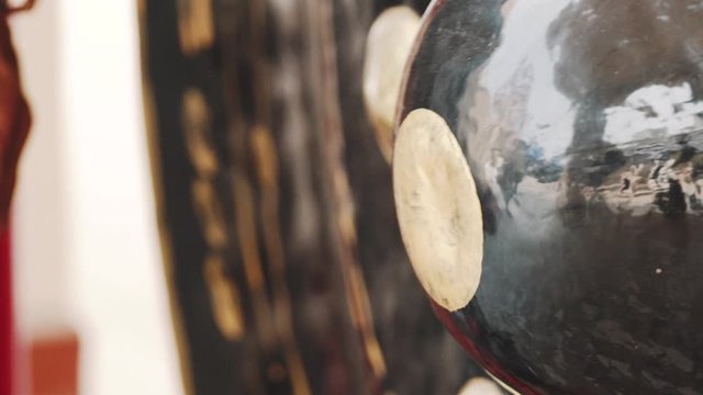 Stroke of a buddhist gong in a tempe in Thailand. Slow motion.