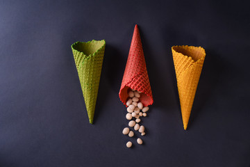 ice cream cone empty, different colors , yellow green blue red. the waffle is already dry. Concept for an ice cream parlor or coffee shop.
