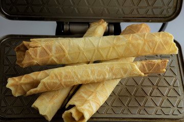 Waffles in a waffle iron, close-up under vegetable angles.