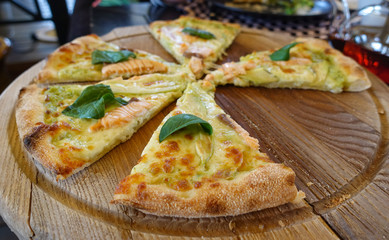 Pizza with salmon and avocado on a wooden tray