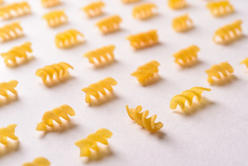 Italian pasta curls on a white background, pattern. Buy food, shop.