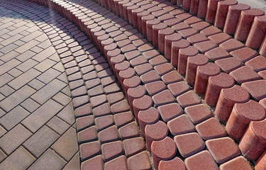 steps made of rounded red paving slabs. City landscape
