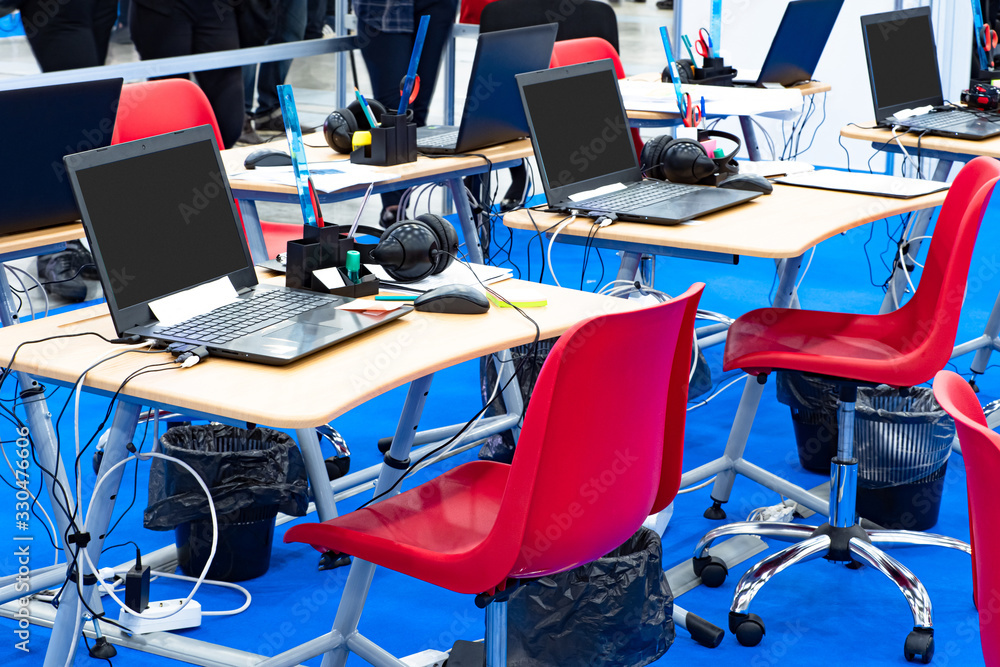 Poster chairs,tables and laptops. jobs engineering workers. the jobs of programmers. work on the creation o