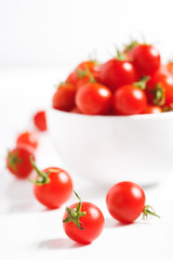 red cherry tomato in  ceramic bowl on white background