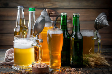 Light beer in a glass, on an old background.