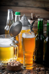 Light frothing beer in a glass, on an old background.