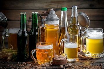 Fototapeta premium Light frothing beer in a glass, on an old background.