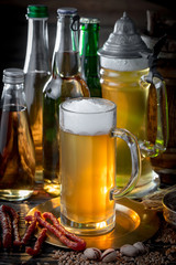 Light frothing beer in a glass, on an old background.