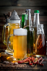 Light beer in a glass, on an old background.