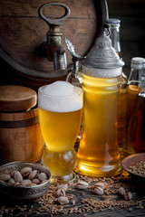 Light beer in a glass, on an old background.