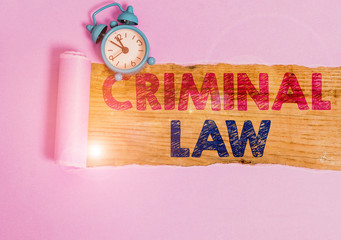 Writing note showing Criminal Law. Business concept for legal system which relates to punishing those commits crime