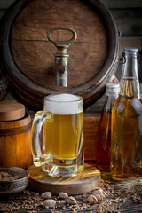 Light frothing beer in a glass, on an old background.
